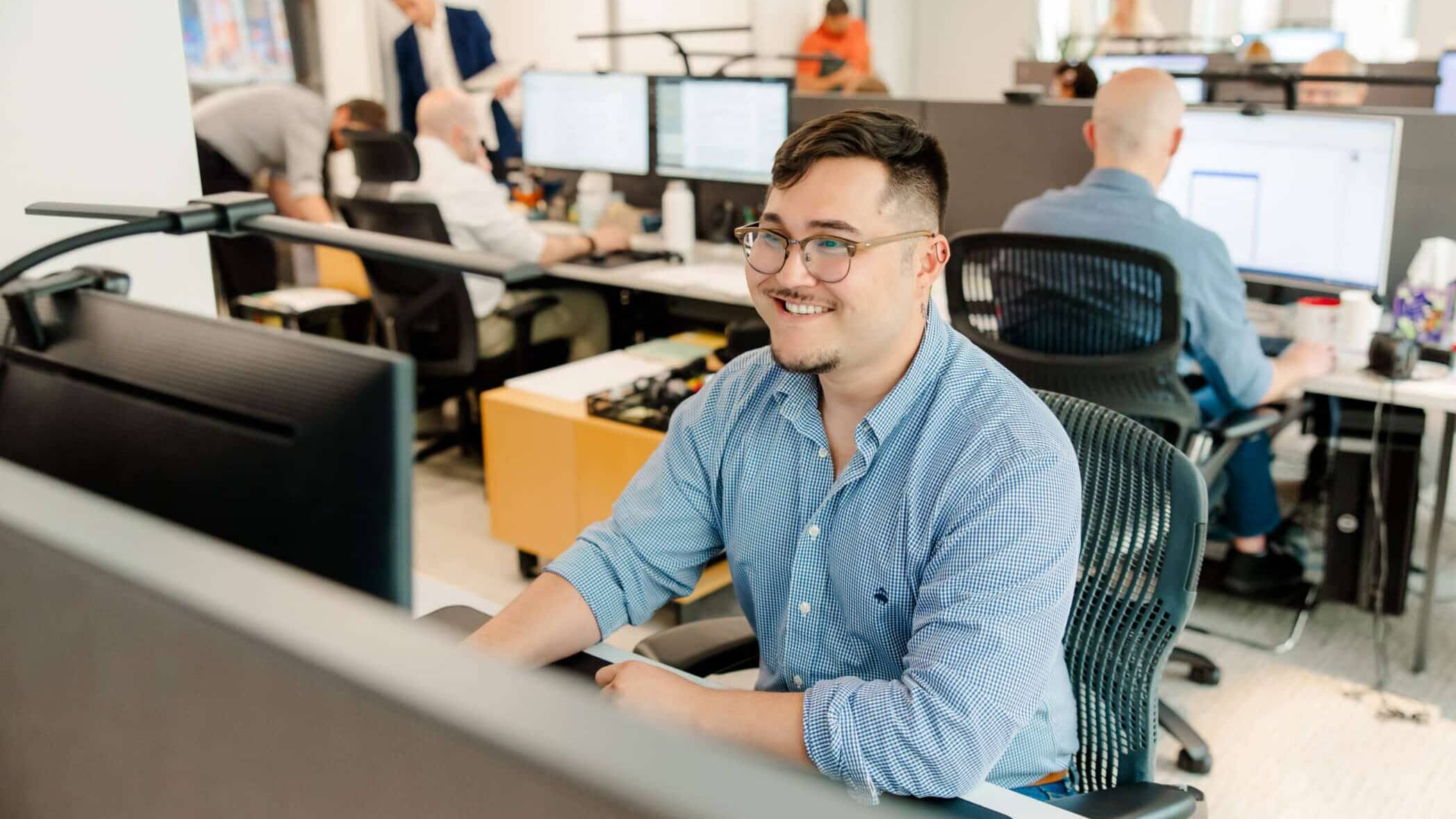 Cole & Denny Architect smiling at computer