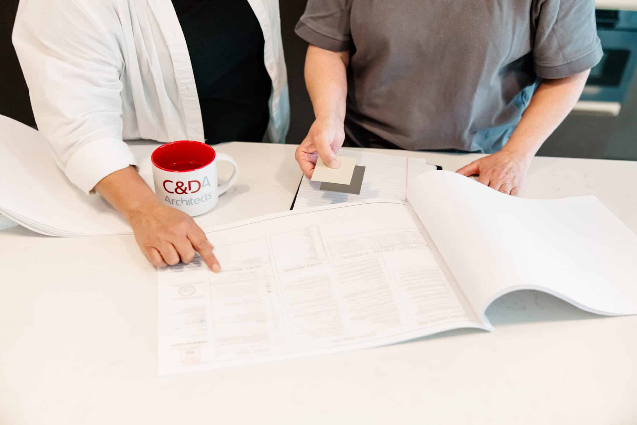 Cole & Denny employees looking at building plans