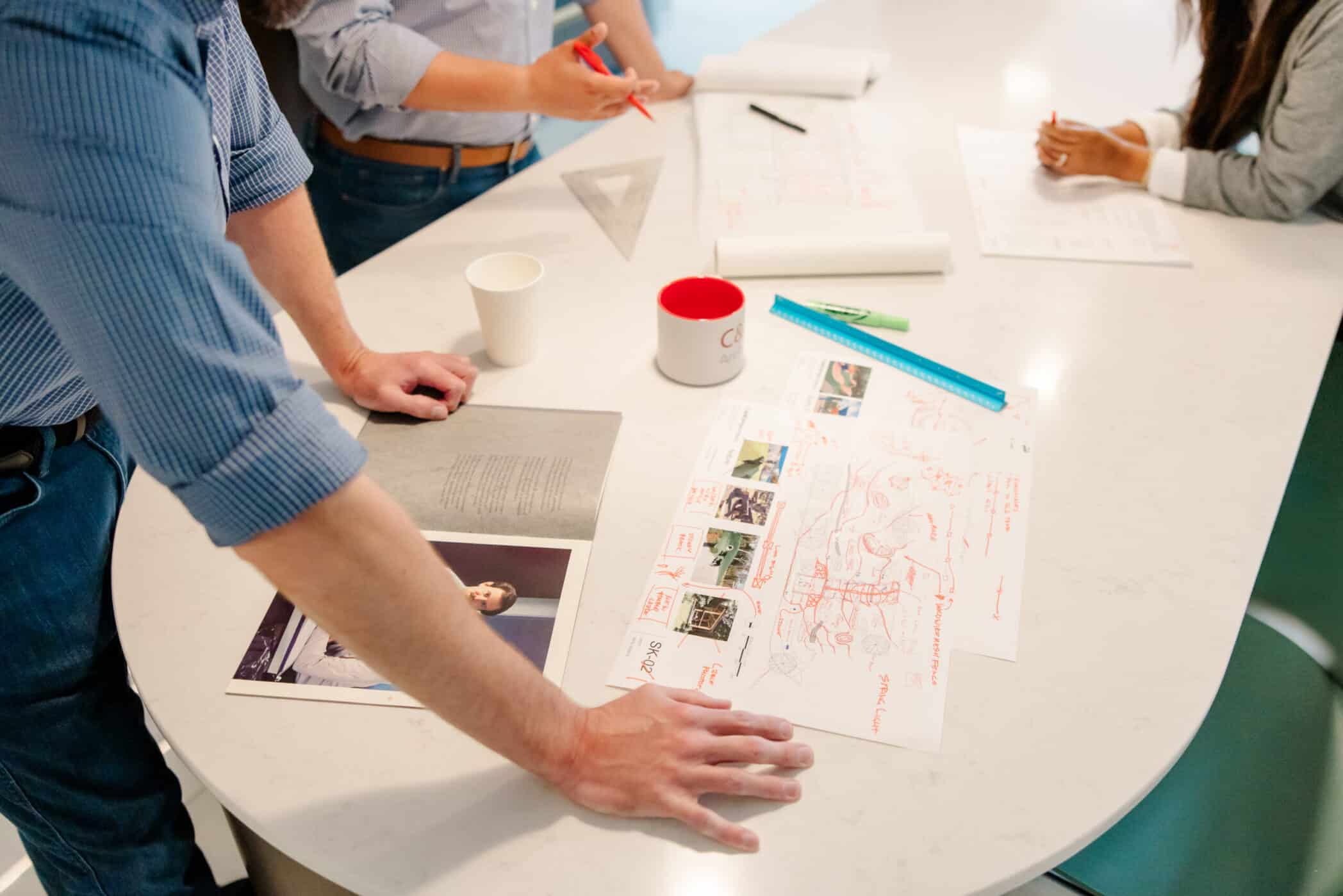 Cole & Denny employees looking at building plans